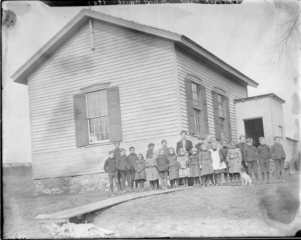 Students in front of the Stony Brook schoolhouse with teacher Mary Louise Snook, 1904. Historical Society of Princeton.
