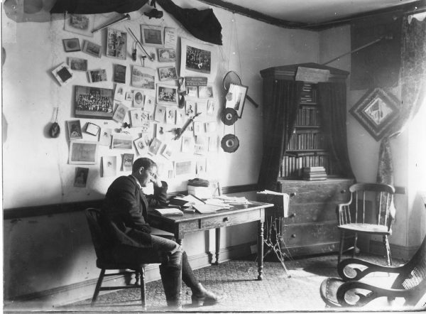 A student reads in his room at the Princeton Theological Seminary, ca. 1900.